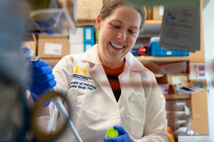Dr. Jennifer Brazil works in the lab.